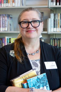 Director Lisa Lintner holding two books